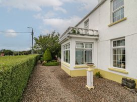 A house with a garden and pathway at Bruckless Rest Fine Country Dining B&B Bruckless