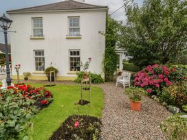 A garden with flowers and a bench at Bruckless Rest Fine Country Dining B&B in Bruckless