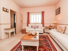 A living room with a sofa and coffee table at Myrtle Cottage in Lynmouth