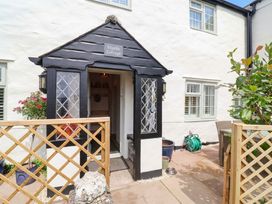 An entrance with a door and sign at Myrtle Cottage in Lynmouth
