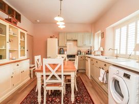 A kitchen with a table and chairs at Myrtle Cottage in Lynmouth