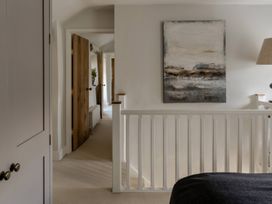 A hallway with doors and artwork at Rose Cottage in Gweek