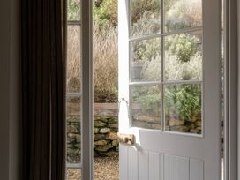 A door opening to a garden view at Rose Cottage in Gweek