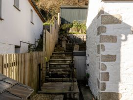 An outdoor space with stairs and walls at Rose Cottage in Gweek
