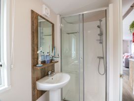 A bathroom with a shower and sink at Caravan in Girvan