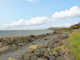 A coastal scene with rocks and grass near the sea at Caravan in Girvan