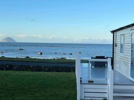 An outdoor view of the sea and rocks at Frontline Sea View : P1 Whilk Meadow Girvan