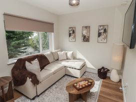 A living room with a corner sofa and coffee table at Flat 4 in Tenby