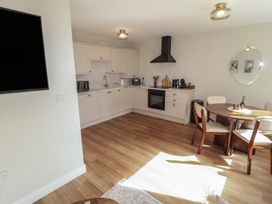 A kitchen with a dining table and chairs at Flat 4 in Tenby