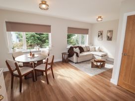 A living room with a sofa and dining area at Flat 4 in Tenby