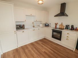 A kitchen with a microwave and oven at Flat 4 in Tenby