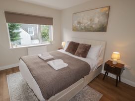 A bedroom with a bed and bedside table at Flat 4 in Tenby