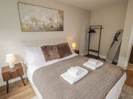 A bedroom with a bed and nightstand at Flat 4 in Tenby