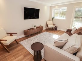 A living room with a television and sofa at Flat 1 in Tenby