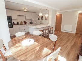 A kitchen with a round table and chairs at Flat 1 in Tenby