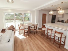 A living room with a dining table and kitchen counter at Flat 1 in Tenby