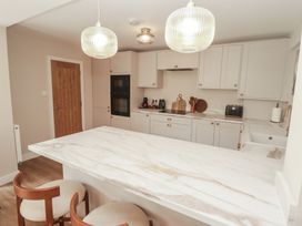 A kitchen with a marble countertop and appliances at Flat 1 in Tenby