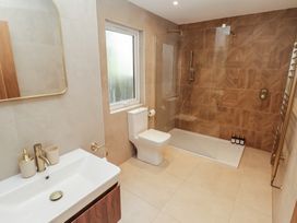 A bathroom with a shower and sink at Flat 1 in Tenby