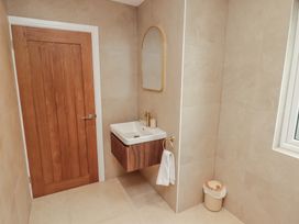 A bathroom with a sink and a mirror at Flat 1 in Tenby