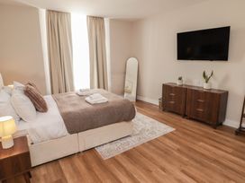 A bedroom with a bed and TV at Flat 1 in Tenby