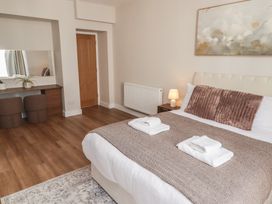 A bedroom with a bed and a desk at Flat 1 in Tenby