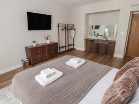 A bedroom with a bed and a television at Flat 1 in Tenby