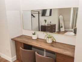 A dressing room with a desk and mirror at Flat 1 in Tenby