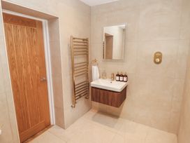 A bathroom with a sink and towel rack at Flat 1 in Tenby
