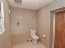 A bathroom featuring a toilet and a shower head at Flat 1 in Tenby