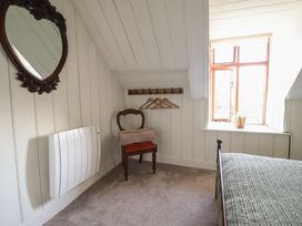 A bedroom with a chair and towel at Waen Fechan in Dolgellau