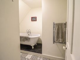 A bathroom with a bathtub and towel rack at Waen Fechan in Dolgellau