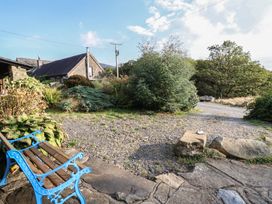 An outdoor area with a bench and plants at Waen Fechan in Dolgellau