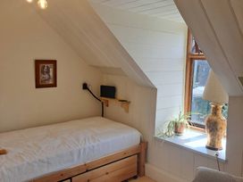 A bedroom with a bed and window at Waen Fechan Dolgellau