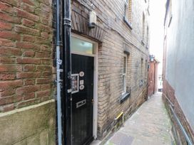 An alleyway with a doorway and brick walls at 1 St. Anns Lane Whitby