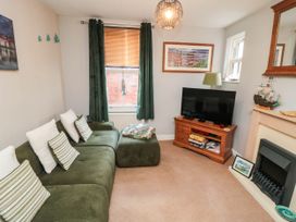A living room with a sofa and television at 1 St. Anns Lane Whitby