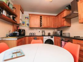 A kitchen with wooden cabinets and appliances at 1 St. Anns Lane, Whitby