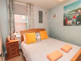 A bedroom with a bed and bedside table at 1 St. Anns Lane in Whitby