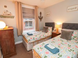 A bedroom with two single beds and a lamp at 1 St. Anns Lane in Whitby