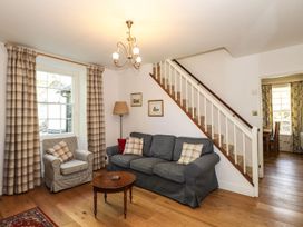A living room with a sofa and armchair at Jessicas Cottage in Windermere