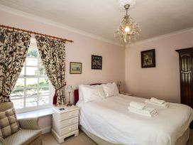 A bedroom with a bed and nightstand at Jessicas Cottage in Windermere