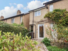 An outdoor area with a house and garden at Coombe Cottage Apartment in Axmouth