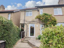 A house with front steps and plants at Coombe Cottage Apartment in Axmouth