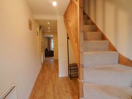 A hallway with staircase and lighting at Coombe Cottage Apartment in Axmouth