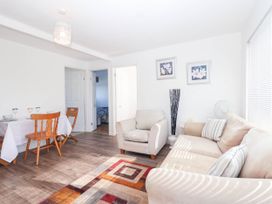 A living room with a sofa and dining table at 122 Norton Park Dartmouth