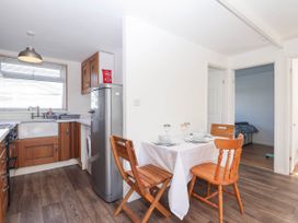 A kitchen with a table and chairs at 122 Norton Park, Dartmouth
