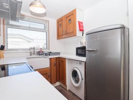 A kitchen with appliances including a refrigerator and a washing machine at 122 Norton Park Dartmouth