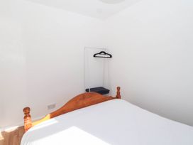 A bedroom with a bed and a hanger on a shelf at 122 Norton Park Dartmouth