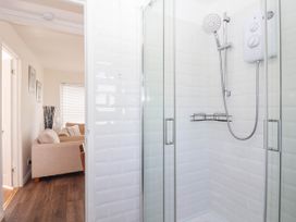 A shower enclosure with a showerhead and shelf at 122 Norton Park Dartmouth
