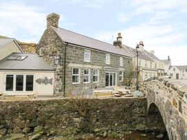 A cafe with stone exterior and bridge in Pwllheli