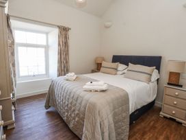 A bedroom with a bed and window at Hen Blas in Pwllheli